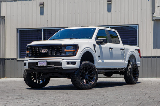2025 Ford F-150 STX with a 6" Rough Country lift kit, 22x12 Fuel Flame wheels, and 35" Fury Country Hunter R/T tires.