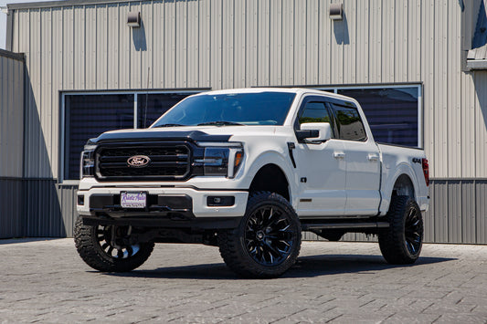 2025 Ford F-150 Lariat with a 6" Rough Country lift kit, 22x12 Fuel Flame wheels, and 35" Fury Country Hunter R/T tires.