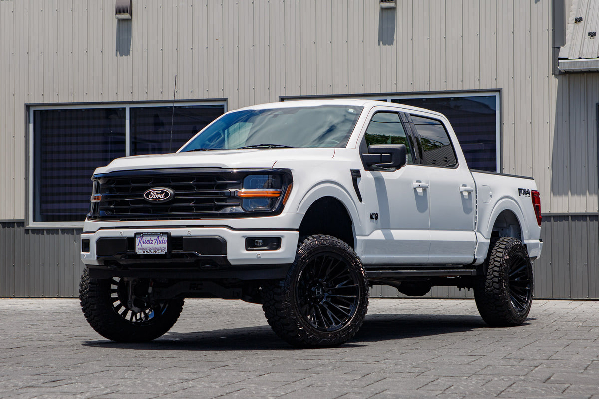 2024 Ford F-150 XLT with a 6" Rough Country lift kit, 22x12 Fuel Flame wheels, and 35" Fury Country Hunter R/T tires.