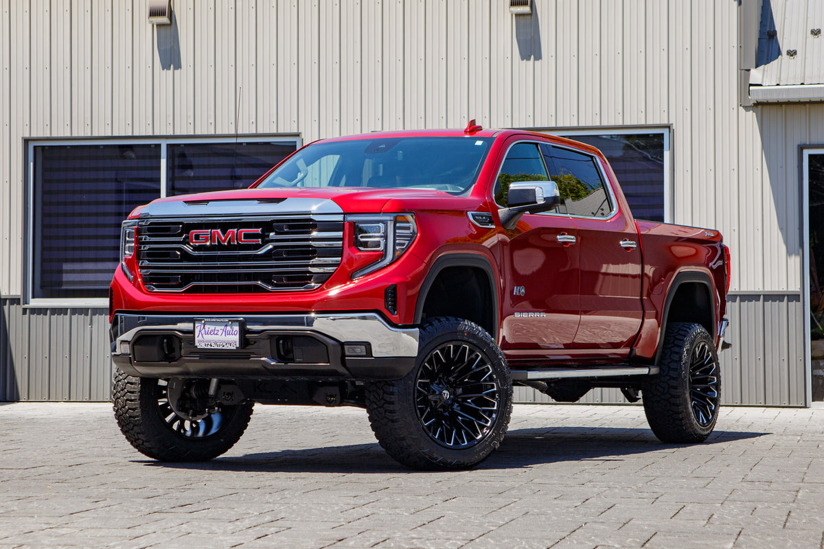 2026 GMC Sierra 1500 SLT with a 6" Rough Country lift kit, 22x12 Fuel Strike wheels, and 35" Fury Country Hunter R/T tires.
