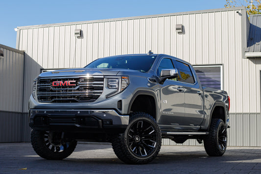 2025 GMC Sierra 1500 SLT with a 6" Rough Country lift kit, 22x12 Fuel Rebar wheels, and 35" Fury Country Hunter R/T tires.