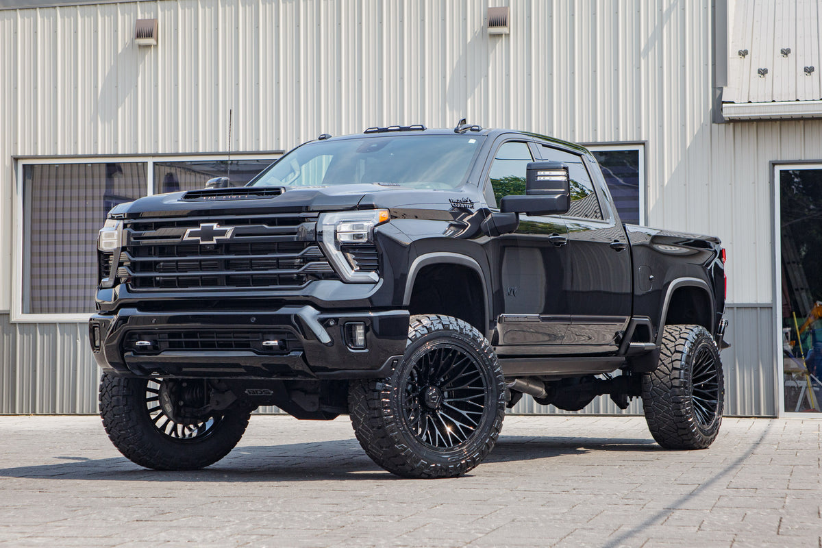 2026 Chevrolet Silverado 2500 High Country with a 5" BDS lift kit, 22x12 TIS 566B wheels, and 37" Nitto Ridge Grappler tires.