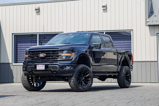 2024 Ford F-150 XLT with a 6" Rough Country lift kit, 22x12 Fuel Flame wheels, and 35" Fury Country Hunter R/T tires.