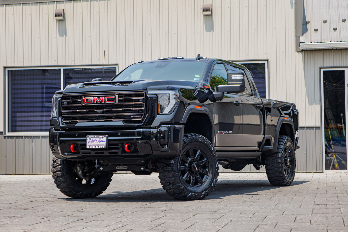 2026 GMC Sierra 2500 AT4X with a 4" MultiMatic lift kit, 20" GMC Stock wheels, and 37" Nitto Mud Grappler tires.