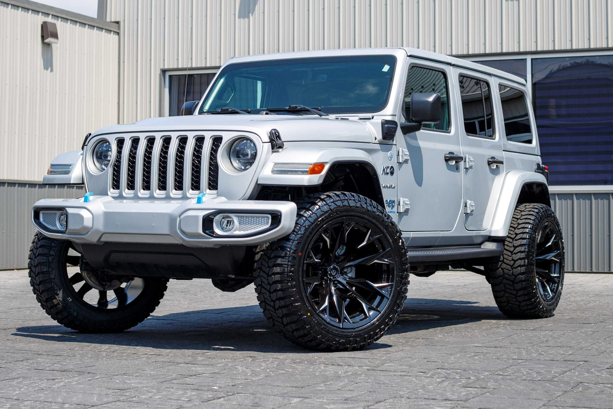 2023 Jeep Wrangler Unlimited Sahara 4XE with a 2.5 Rough Country lift kit, 22x12 Fuel Flame wheels, and 35" Avix Trailtek R/T tires.