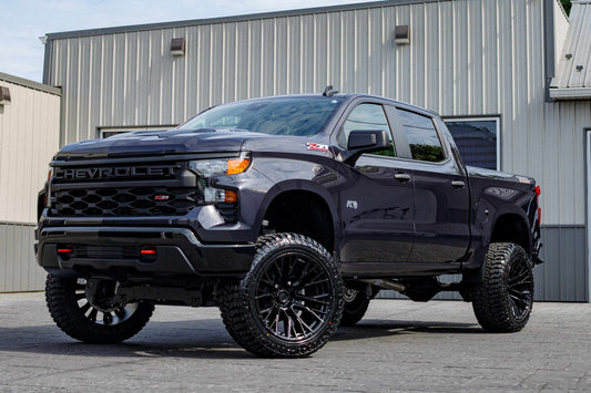 2024 Chevrolet Silverado 1500 Custom Trail Boss with a 6" Rough Country lift kit, 22x12 Fuel Rebar wheels, and 35" Avix Trailtek tires.