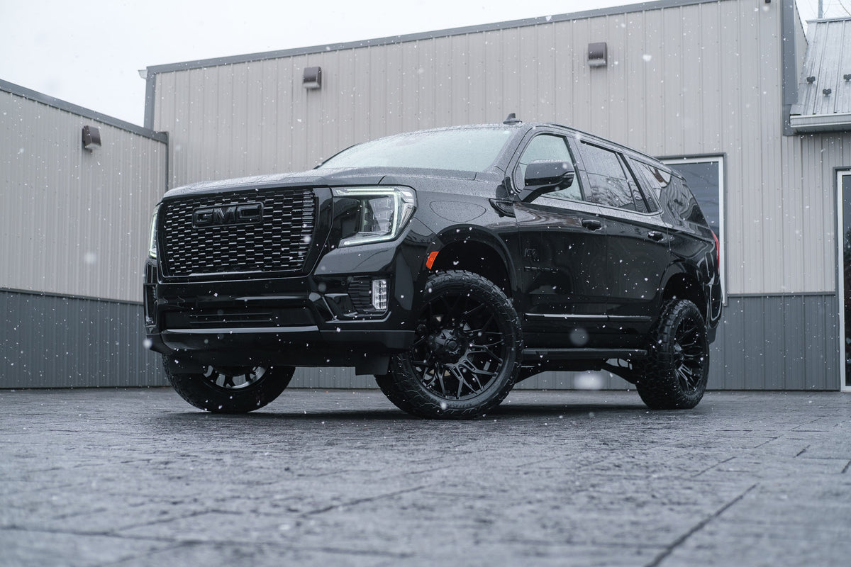 2023 GMC Yukon Denali with a 3" ReadyLift lift kit, 22x10 Fuel Twitch wheels, and 295/50 Toyo Open Country A/T III.