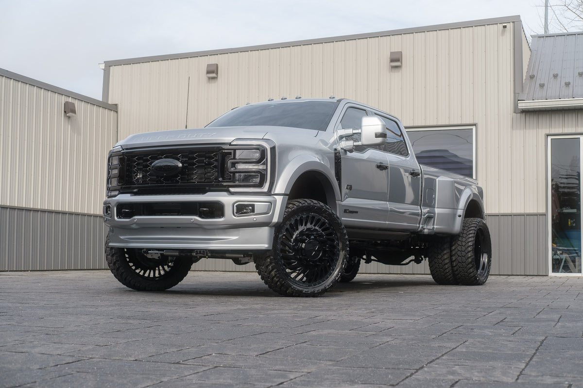 2024 Ford F-450 Super Duty Limited with a 4" Wicked lift kit, 26x8.25 American Force Thriller wheels, and 37" AMP Terrain Attack M/T A tires.