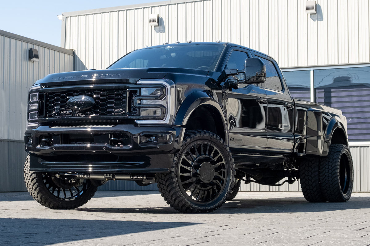 2024 Ford F-450 Super Duty Platinum with a 4" Wicked lift kit, 26x8.25 JTX Omen Black wheels, and 37" AMP Terrain Attack M/T A tires.