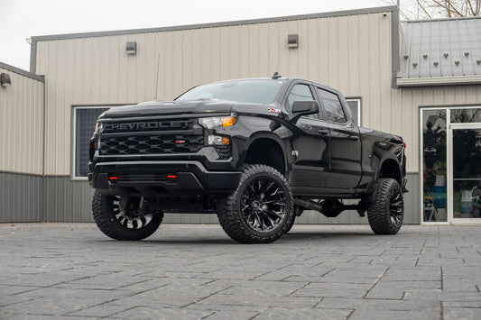 2025 Chevrolet Silverado 1500 Custom Trail Boss with a 6" Rough Country lift kit, 22x12 Fuel Flame wheels, and 35" Fury Country Hunter R/T tires.
