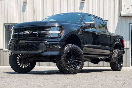 2025 Ford F-150 STX with a 6" Rough Country lift kit, 22x12 Hostile Justice wheels, and 35" Fury Country Hunter R/T tires.