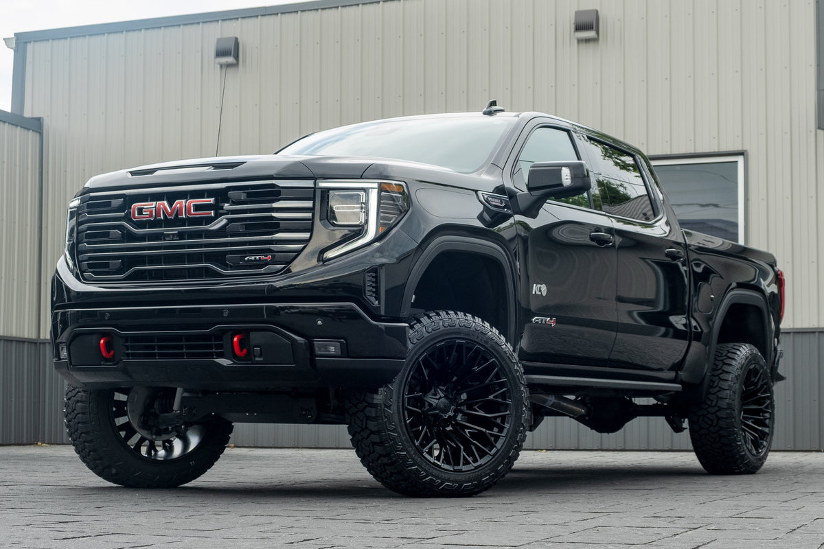 2026 GMC Sierra 1500 AT4 with a 6" Rough Country lift kit, 22x12 Fuel Strike wheels, and 35" Fury Country Hunter R/T tires.