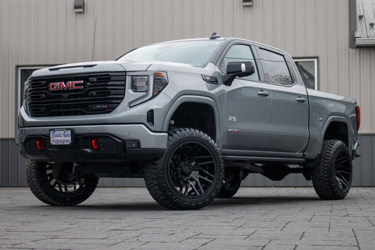 2023 GMC Sierra 1500 AT4 with a 6" Rough Country lift kit, 22x12 TIS 554B wheels, and 35" Fury Country Hunter R/T tires.