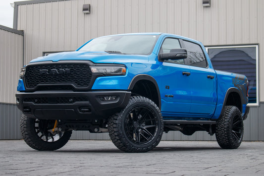 2025 Ram 1500 Rebel with a 6" Rough Country lift kit, 22x12 Arena Battle wheels, and 35" Fury Country Hunter R/T tires.