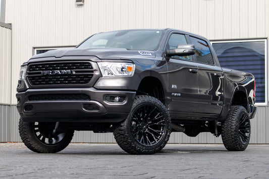 2023 Ram 1500 Big Horn with a 6" Rough Country lift kit, 22x12 Fuel Rebar wheels, and 35" Fury Country Hunter R/T tires.