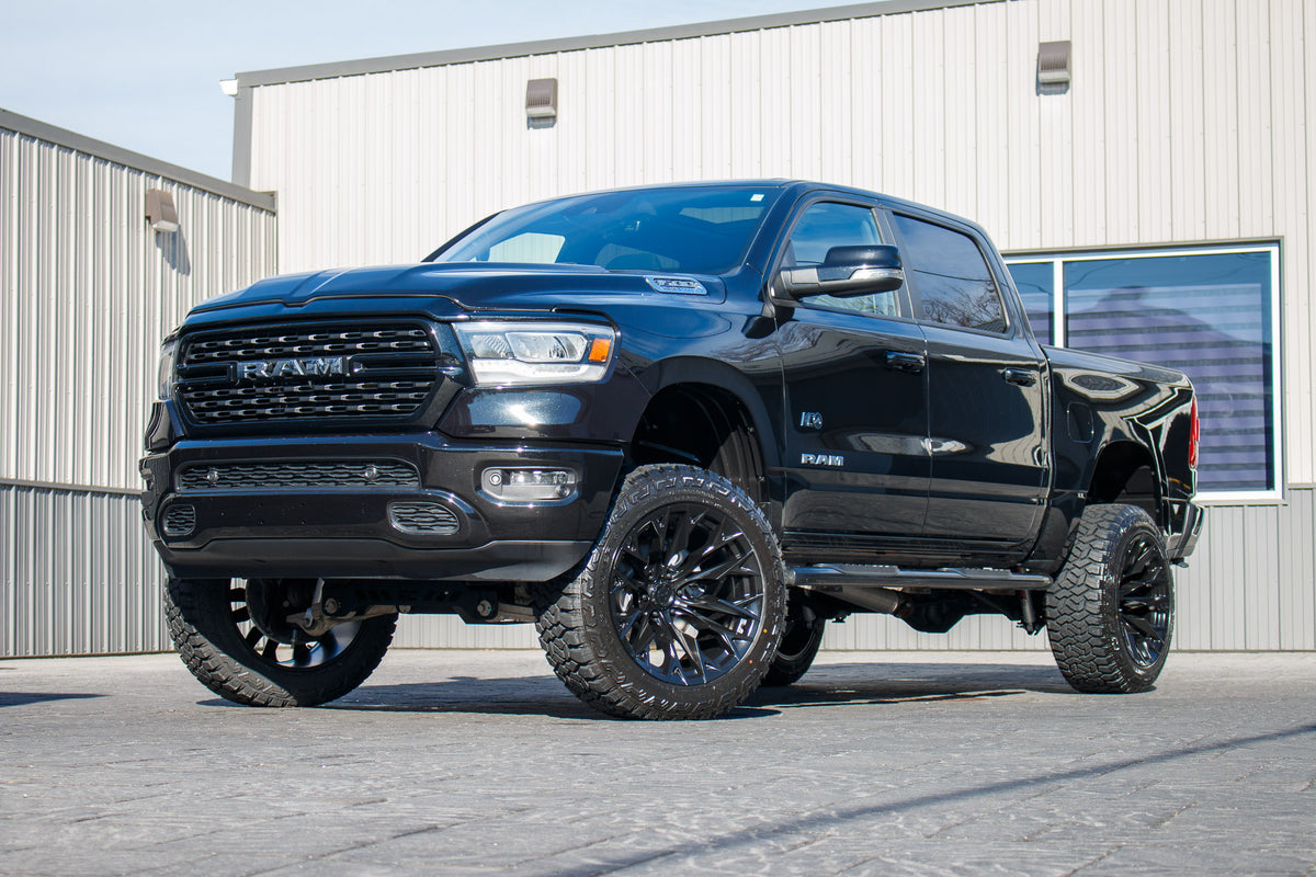 2022 Ram 1500 Big Horn with a 6" Rough Country lift kit, 22x12 Fuel Flame wheels, and 35" Fury Country Hunter R/T tires.