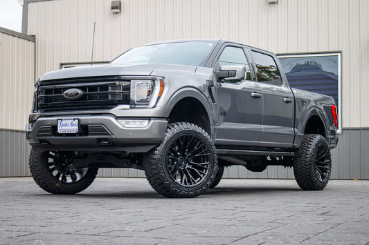 2023 Ford F-150 Lariat with a 6" Rough Country lift kit, 22x12 Fuel Rebar wheels, and 35" Fury Country Hunter R/T tires.