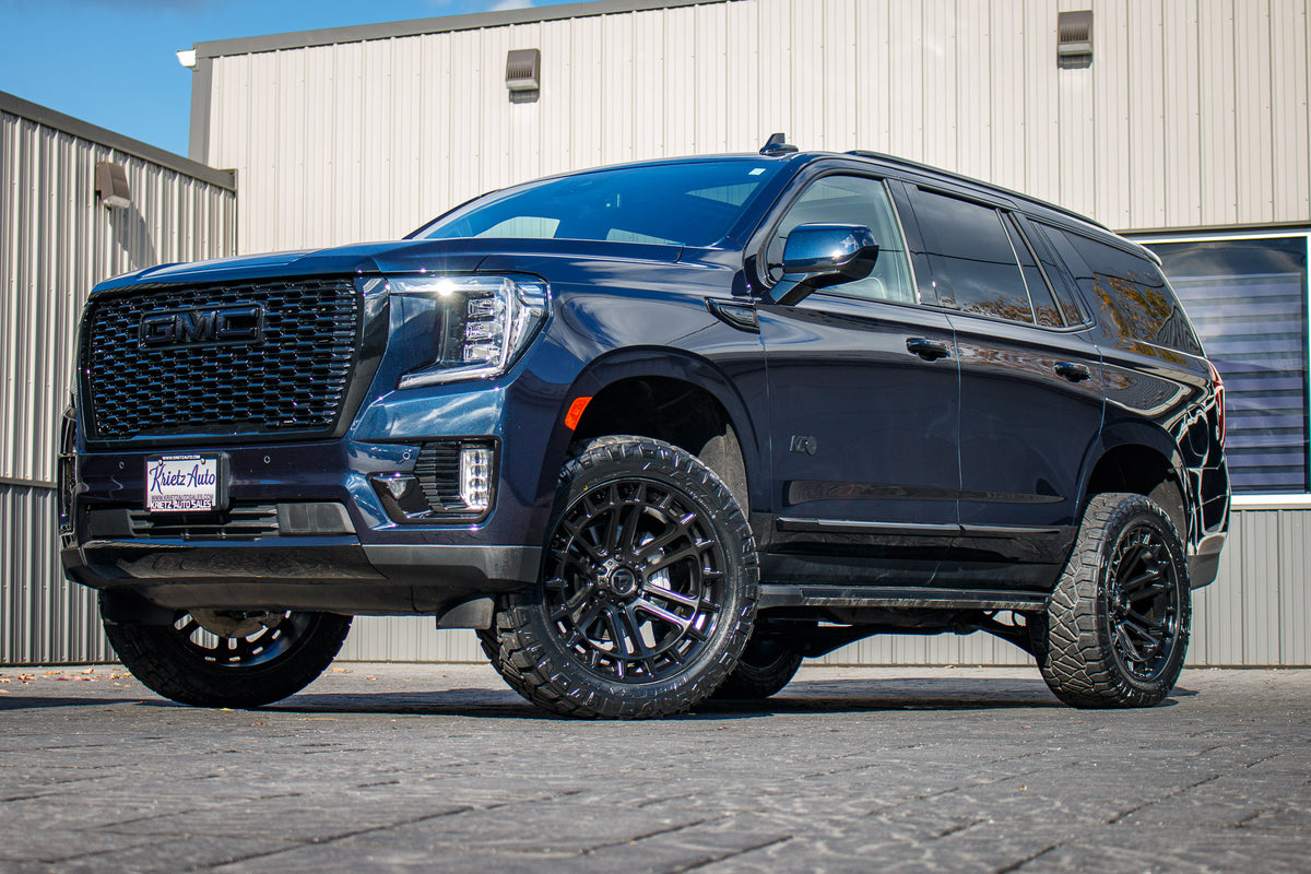 2023 GMC Yukon SLT with a 3" ReadyLift lift kit, 22x10 Fuel Heater wheels, and 295/50 Nitto Ridge Grappler tires.