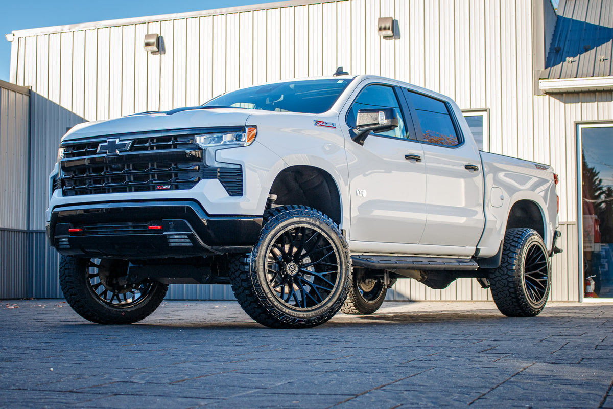 2023 Chevrolet Silverado 1500 LT Trail Boss with a 6" Rough Country lift kit, 22x12 TIS 566B wheels, and 35" Fury Country Hunter R/T tires.