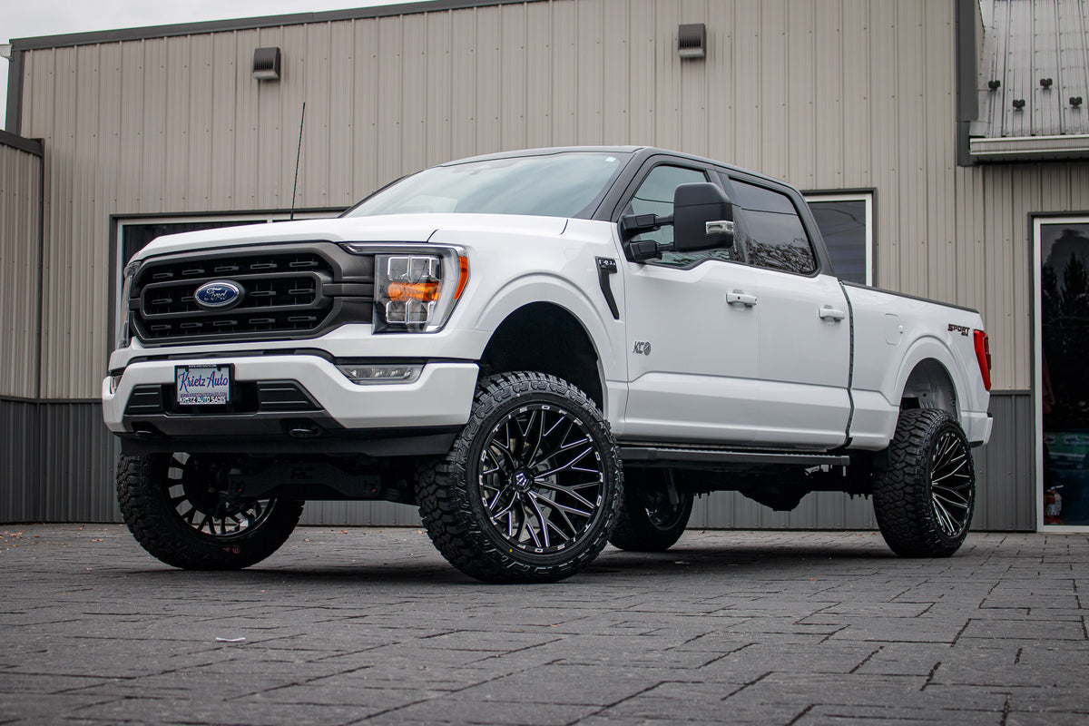 2023 Ford F-150 XLT with a 6" Rough Country lift kit, 22x12 TIS 566BM wheels, and 35" Fury Country Hunter R/T tires.