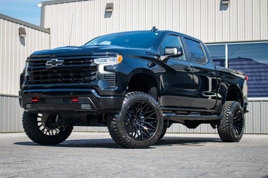 2025 Chevrolet Silverado 1500 LT Trail Boss with a 6" Rough Country lift kit, 22x12 TIS 566B wheels, and 35" Fury Country Hunter R/T tires.