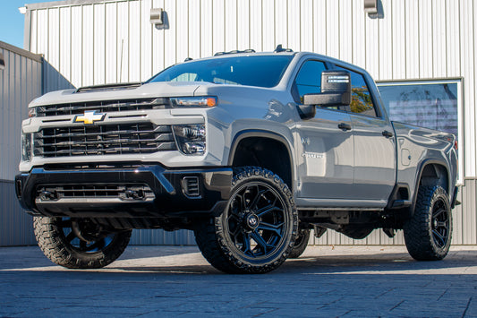 2024 Chevrolet Silverado 2500 Custom with a 3" Rough Country lift kit, 22x10 Fuel Siege wheels, and 35" Nitto Ridge Grappler tires.