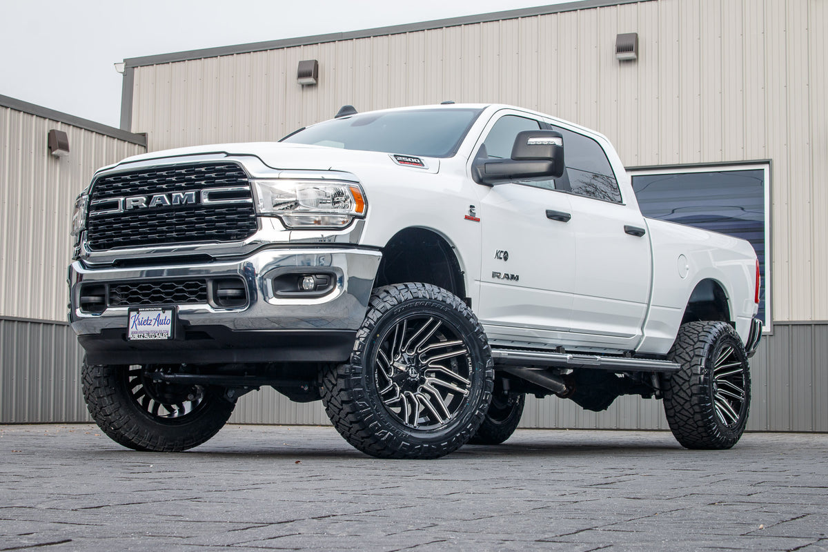 2024 Ram 2500 Big Horn with a 5" Rough Country lift kit, 22x12 Fuel Typhoon wheels, and 37" Nitto Ridge Grappler tires.