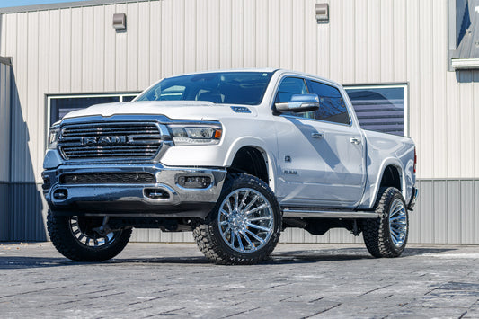 2022 Ram 1500 Laramie with a 6" Rough Country lift kit, 22x12 Hostile Typhoon wheels, and 35" Fury Country Hunter R/T tires.