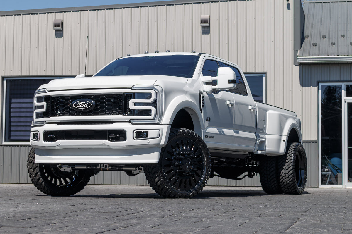 2024 Ford F-450 Super Duty Platinum with a 4" Wicked lift kit, 26x8.25 American Force Massive wheels, and 37" AMP Terrain Attack M/T A tires.