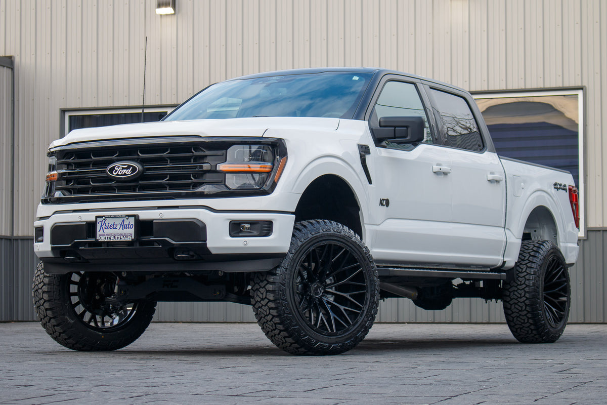 2024 Ford F-150 XLT with a 6" Rough Country lift kit, 22x12 TIS 566B wheels, and 35" Fury Country Hunter R/T tires.