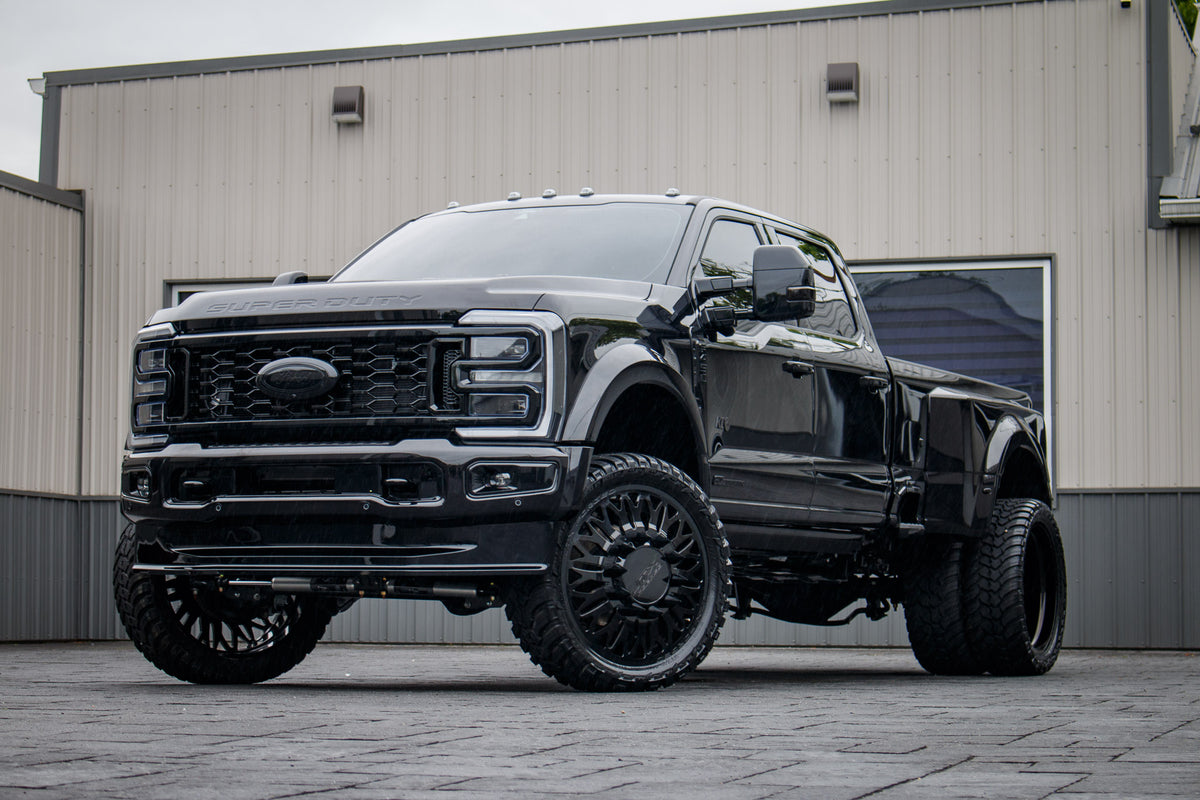 2025 Ford F-450 Super Duty Platinum with a 4" Wicked lift kit, 26x8.25 JTX Vanquish Black wheels, and 37" AMP Terrain Attack M/T A tires.
