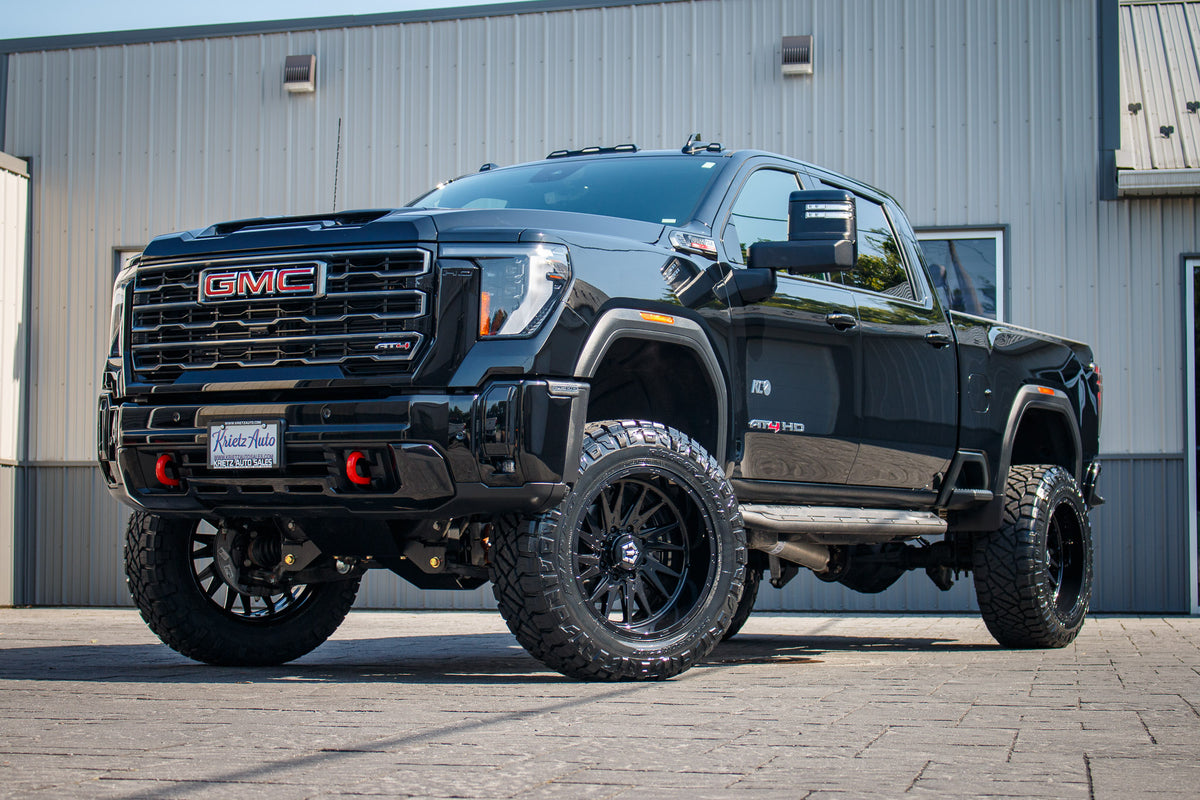 2025 GMC Sierra 2500 AT4 with a 5" BDS lift kit, 22x12 TIS 547B wheels, and 37" Nitto Ridge Grappler tires.