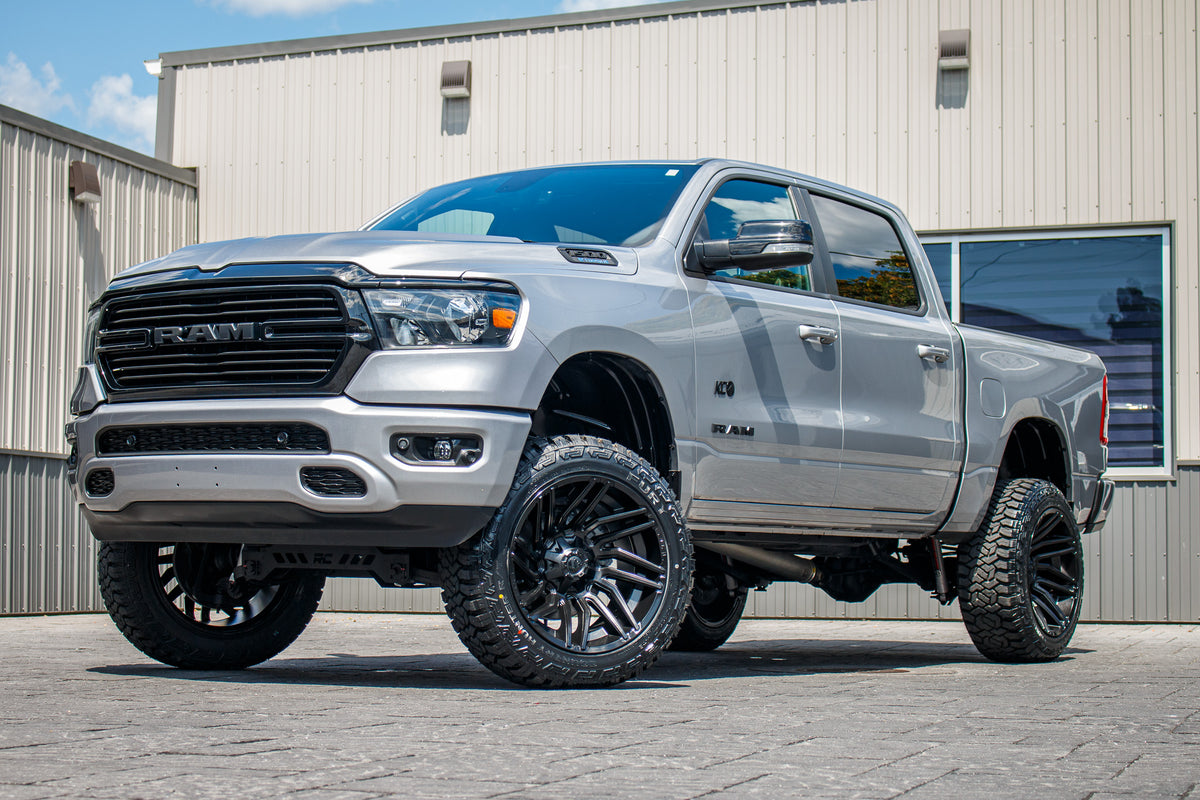 2021 Ram 1500 Big Horn with a 6" Rough Country lift kit, 22x12 Fuel Typhoon wheels, and 35" Fury Country Hunter R/T tires.