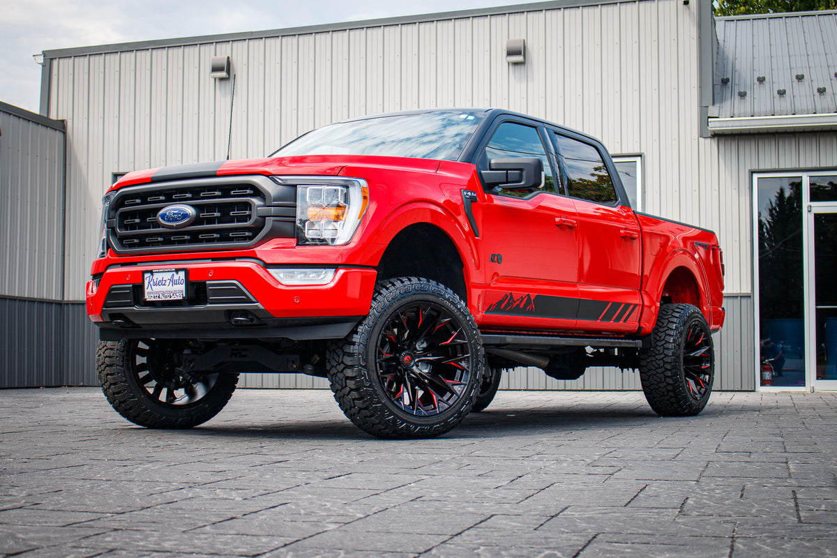 2023 Ford F-150 XLT with a 6" Rough Country lift kit, 22x12 Fuel Flame wheels, and 35" Fury Country Hunter R/T tires.