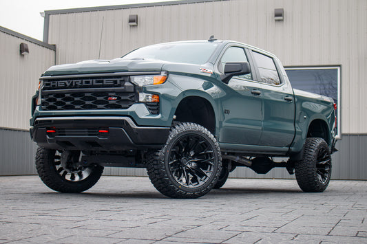 2025 Chevrolet Silverado 1500 Custom Trail Boss with a 6" Rough Country lift kit, 22x12 Fuel Flame wheels, and 35" Fury Country Hunter R/T tires.
