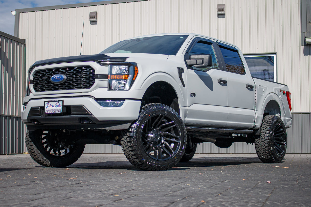 2023 Ford F-150 XLT with a 6" Rough Country lift kit, 22x12 Fuel Typhoon wheels. and 35" Fury Country Hunter R/T tires.