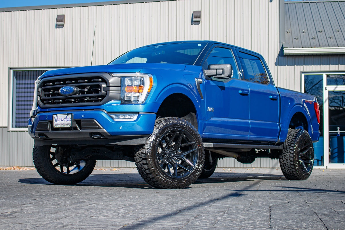 2023 Ford F-150 XLT with a 6" Rough Country lift kit, 22x12 Fuel Flux wheels, and 35" Fury Country Hunter R/T tires.