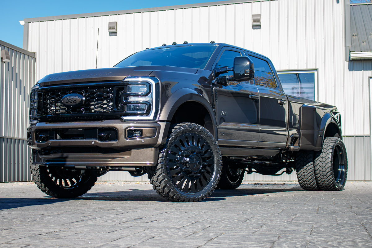 2024 Ford F-450 Super Duty Limited with a 4" Wicked lift kit, 26x8.25 American Force Massive wheels, and 37" AMP Terrain Attack M/T A tires.