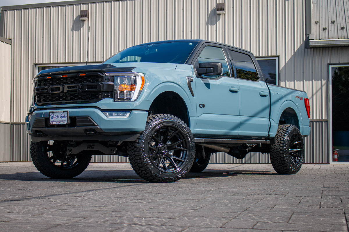 2023 Ford F-150 XLT with a 6" Rough Country lift kit, 22x12 Fuel Catalyst wheels, and 35" Fury Country Hunter R/T tires.