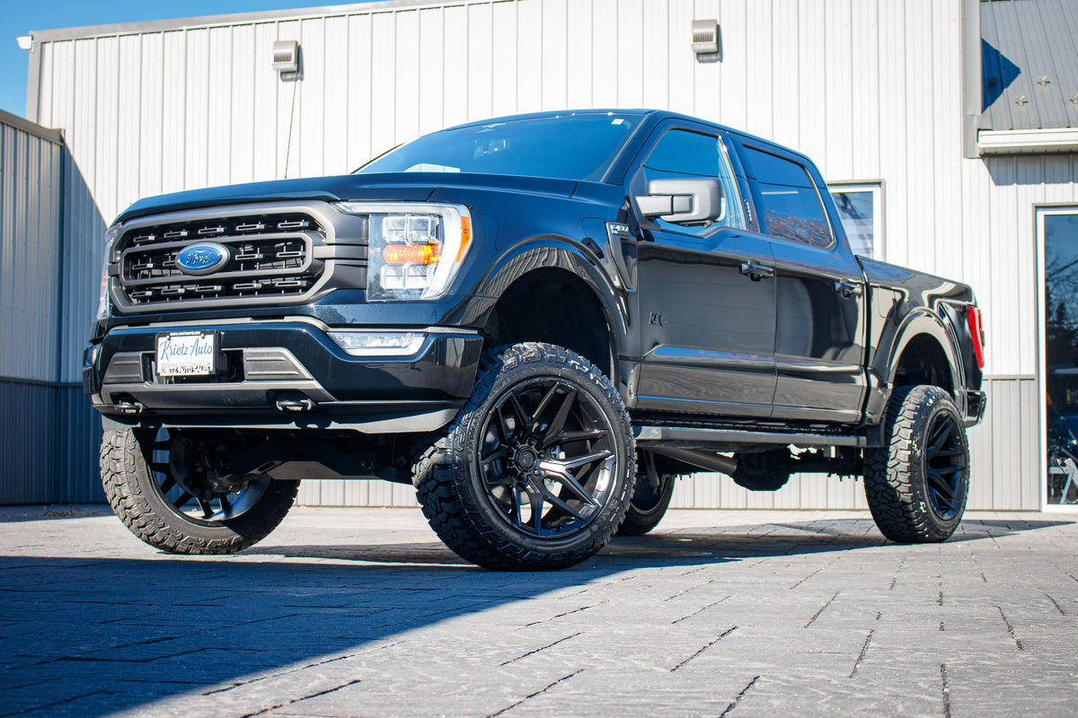 2023 Ford F-150 XLT with a 6" Rough Country lift kit, 22x12 Fuel Flux wheels, and 35" Fury Country Hunter R/T tires.