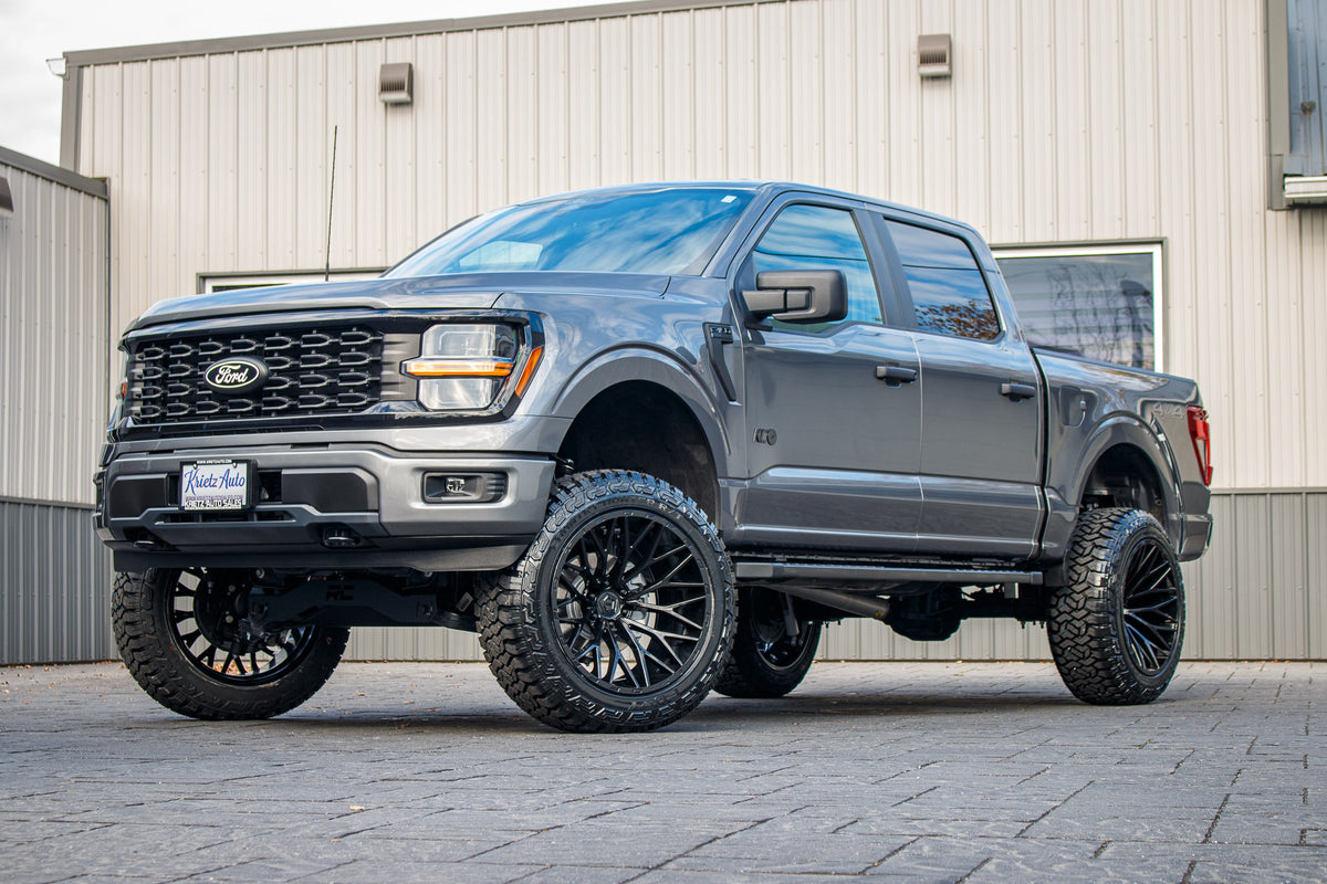 2024 Ford F-150 STX with a 6" Rough Country lift kit, 22x12 TIS 566B wheels, and 35" Fury Country Hunter R/T tires.